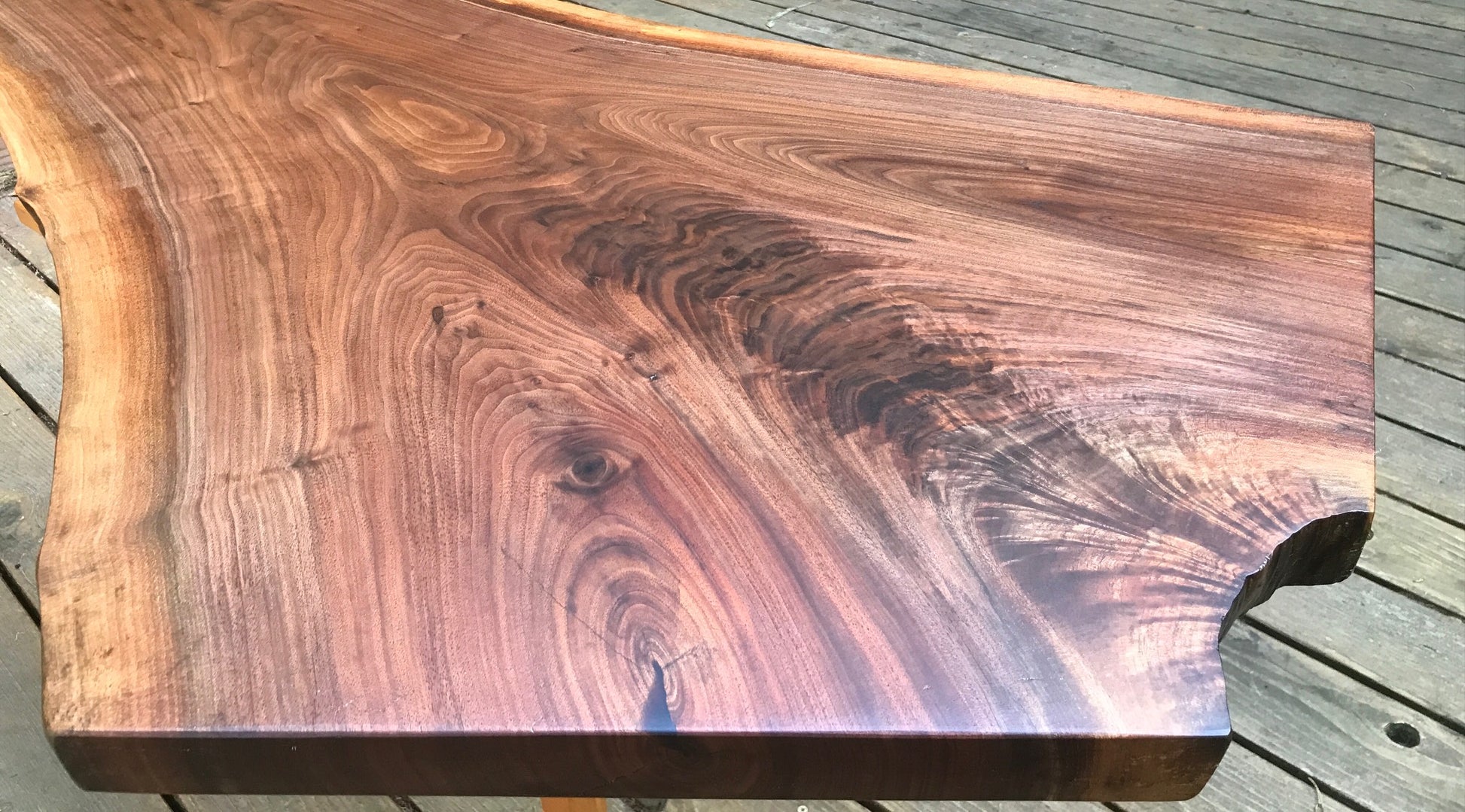 Live edge walnut coffee table in natural light - close up partial view