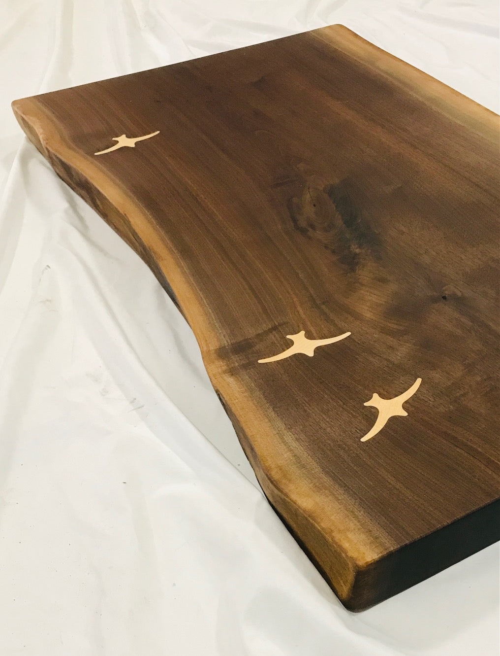 Live edge walnut coffee table with maple seabird inlay - partial 45degree view